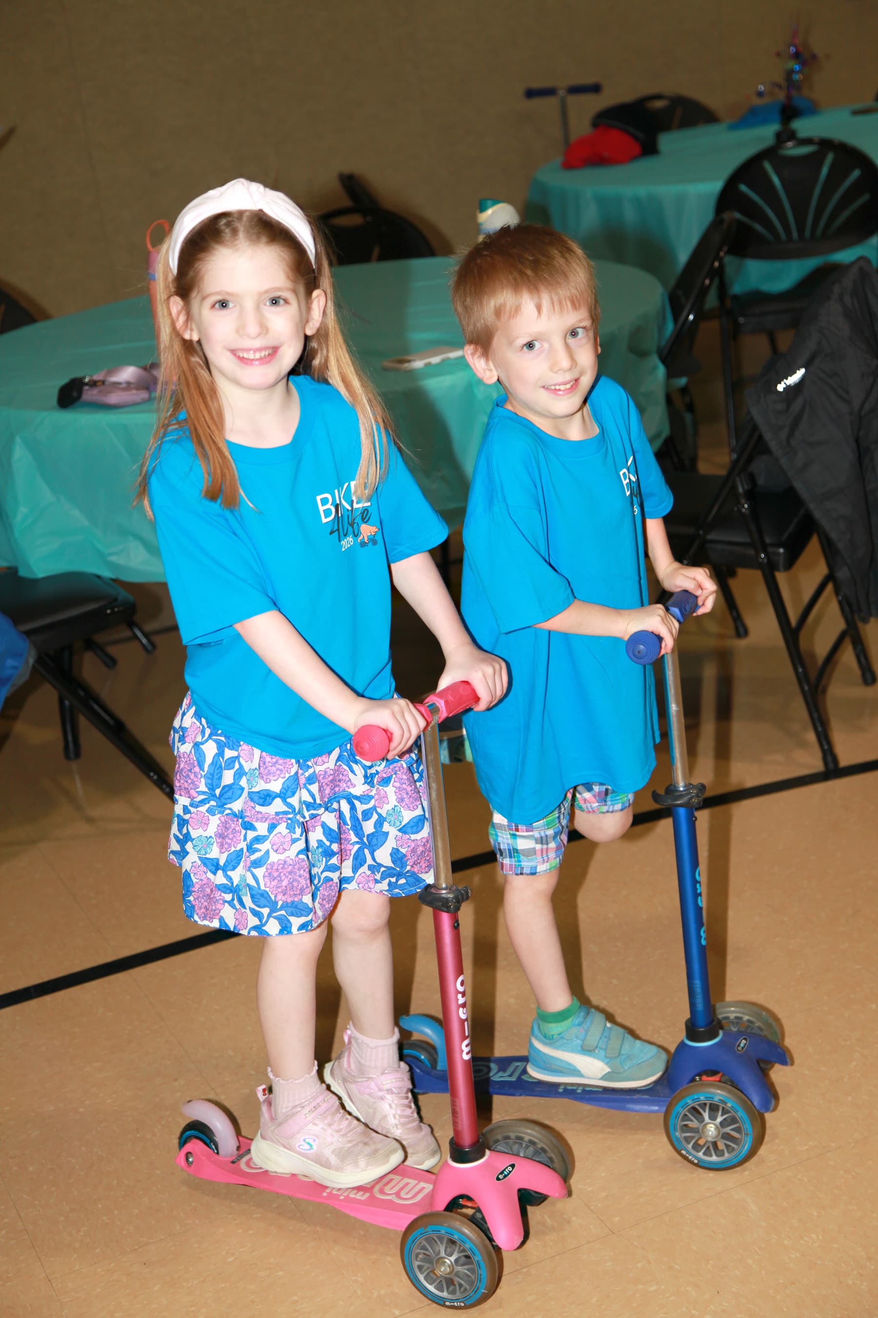 Kids on scooters wearing Bike4Life shirts